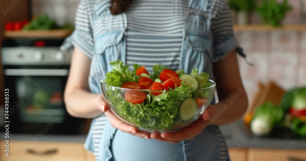A Pregnant Woman Tenderly Holding a Bowl of Fresh, Healthy Salad