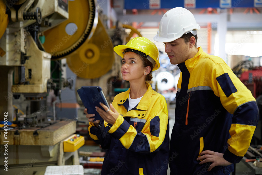 workers or engineers working on tablet and checking product in the metal sheet factory workers or engineers working on tablet and checking product in the metal sheet factory