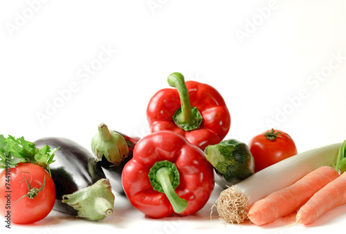 group of assorted vegetables on white background and copy space. bell pepper, leek, tomato, zucchini, aubergine.