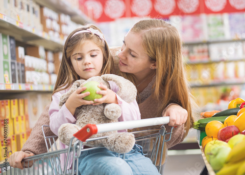 Mother and daughter in the produce section at the supermarket