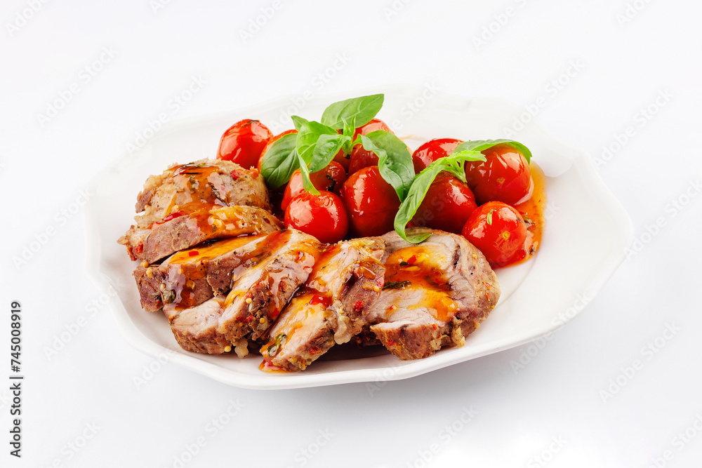 Baked meatloaf with spinach and tomatoes isolated on white