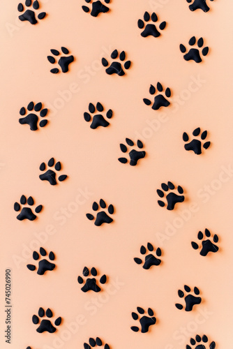 Embossed felt dog prints on light peach background, neat and aligned.