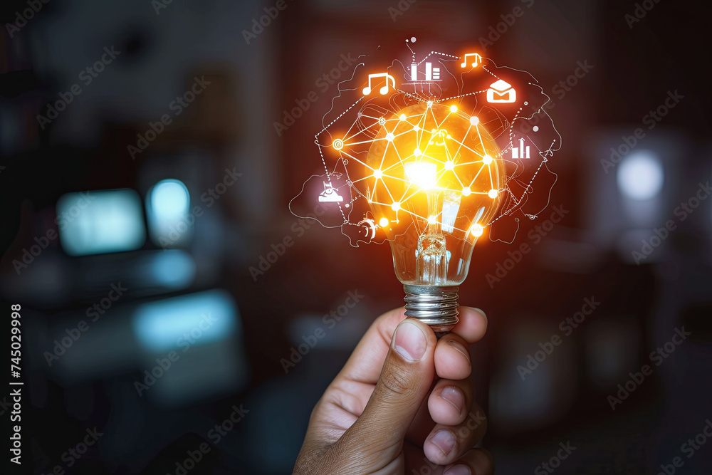 A hand holds a light bulb with business digital marketing innovation technology icons on a network in the background - obrazy, fototapety, plakaty 