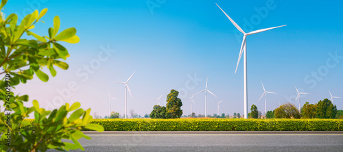 Clean roads and wind energy: renewable energy. EV Charger station. Environmentally responsible logistics industry with clean energy. Wind turbines generate electricity in vast fields. panoramic image 