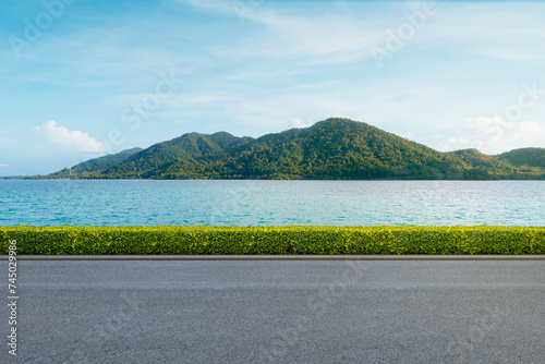 Fototapeta Naklejka Na Ścianę i Meble -  Beautiful beach road in Thailand and Majestic Mountains island in background.