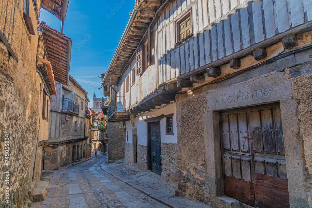 Timber houses alongside a narrow street in La Alberca village in Spain