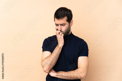 Caucasian handsome man over isolated background having doubts