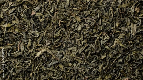 Heap of dry leaves green tea top view, rotation