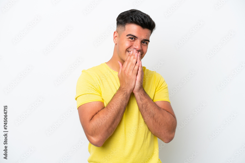 Young caucasian handsome man isolated on white background keeps palm together. Person asks for something