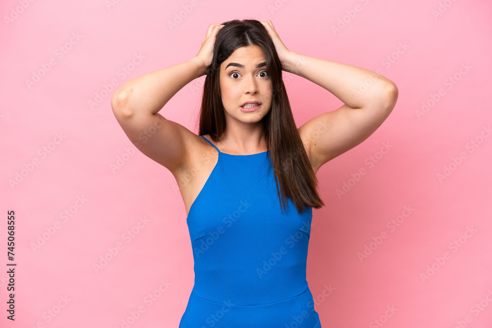 Young Brazilian woman isolated on pink background doing nervous gesture Young Brazilian woman isolated on pink background doing nervous gesture