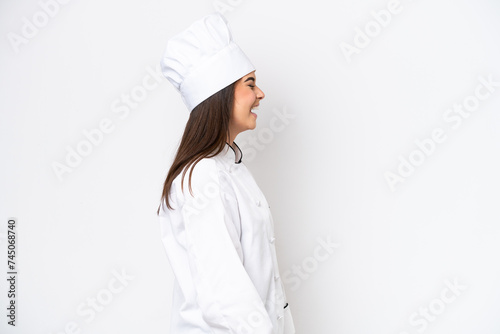 Young Brazilian chef woman isolated on white background laughing in lateral position photo