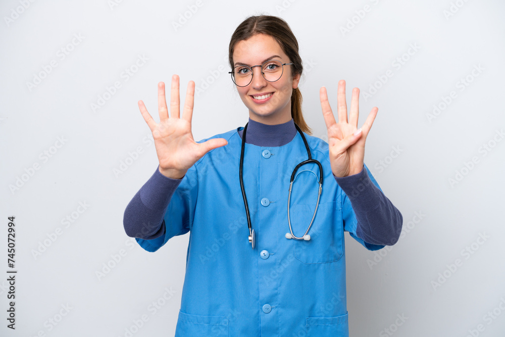 Young caucasian nurse woman isolated on white background counting nine with fingers Young caucasian nurse woman isolated on white background counting nine with fingers