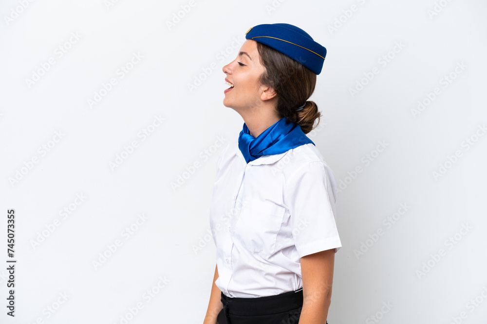 Airplane stewardess caucasian woman isolated on white background laughing in lateral position Airplane stewardess caucasian woman isolated on white background laughing in lateral position