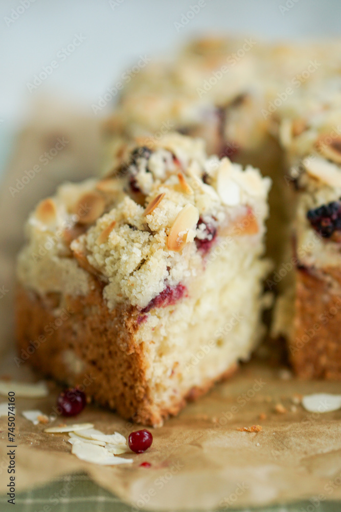 Home made coffee cake with apples with cramb topping and almond slices on crafte background close up selective focus Home made coffee cake with apples with cramb topping and almond slices on crafte background close up selective focus