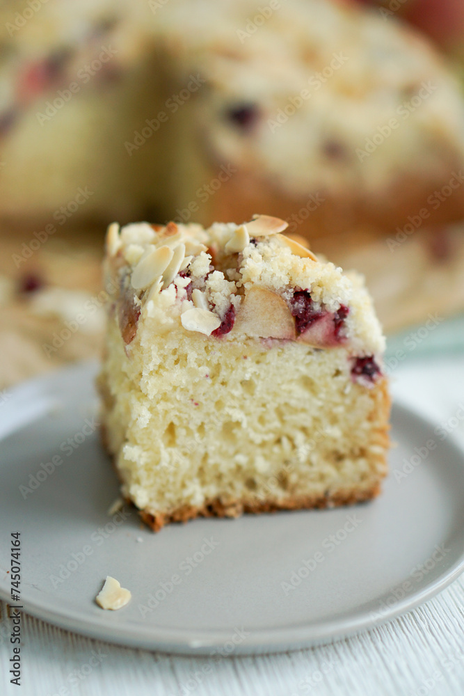 Home made coffee cake with apples with cramb topping and almond slices on crafte background close up selective focus Home made coffee cake with apples with cramb topping and almond slices on crafte background close up selective focus