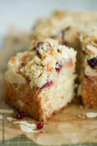 Home made coffee cake with apples with cramb topping and almond slices on crafte background close up selective focus