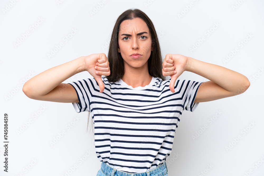 Young caucasian woman isolated on white background showing thumb down with two hands Young caucasian woman isolated on white background showing thumb down with two hands