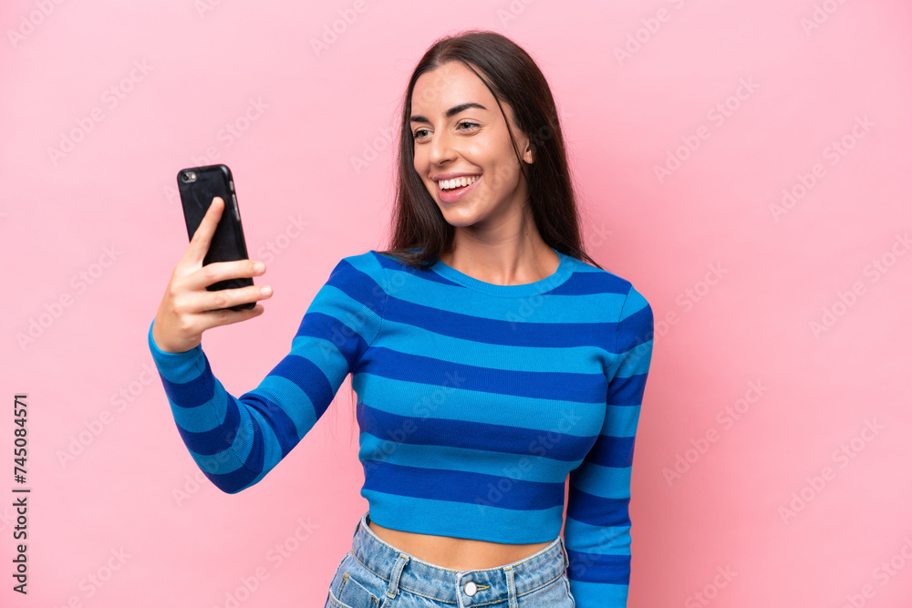 Young caucasian woman isolated on pink background making a selfie Young caucasian woman isolated on pink background making a selfie