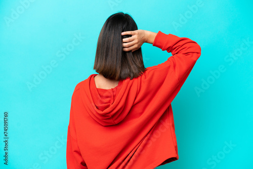 Young caucasian woman isolated on blue background laughing