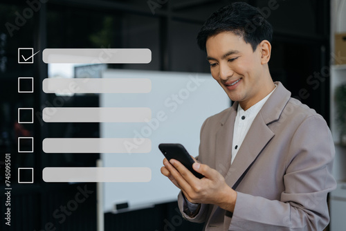 Business performance checklist concept, businessman using tablet and laptop doing online checklist survey, filling out digital form checklist.