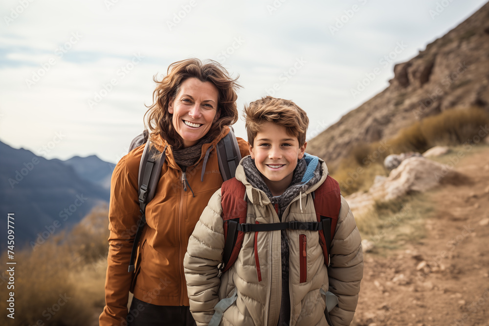 Mother and son at outdoors with mountaineer backpack