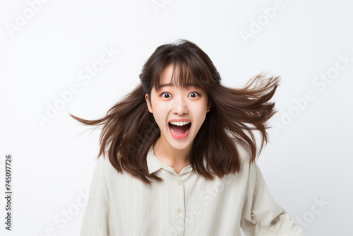 Teen pretty Japanese girl over isolated white background © luismolinero