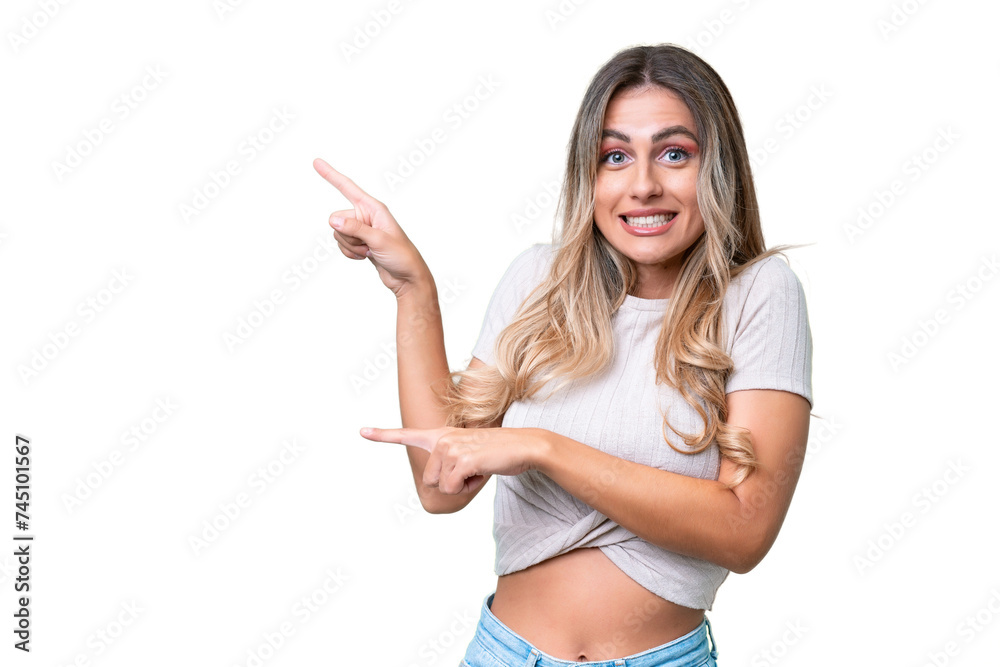 Young Uruguayan woman over isolated background frightened and pointing to the side Young Uruguayan woman over isolated background frightened and pointing to the side