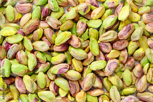 Peeled pistachio nuts background texture