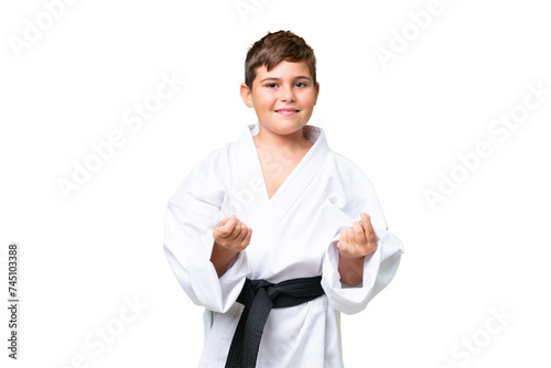 Little caucasian kid doing karate over isolated chroma key background making money gesture