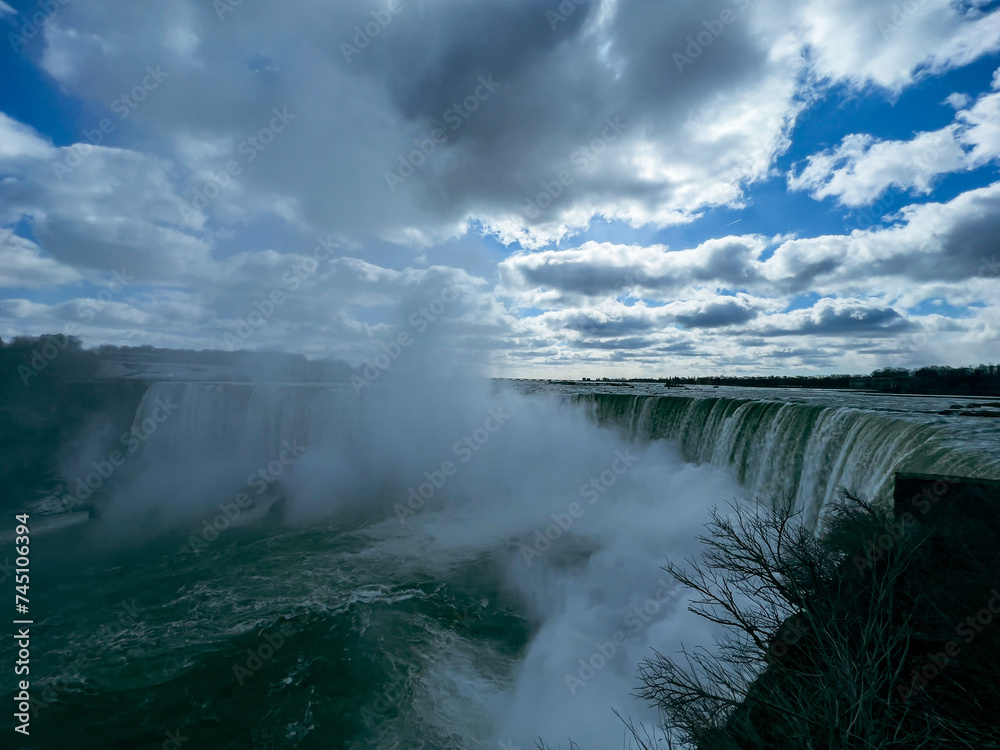 Niagara Falls, Ontario, Canada. Niagara Falls is the largest waterfall in the world. Beautiful view fro the ground near waterfall Niagara Falls, Ontario, Canada. Niagara Falls is the largest waterfall in the world. Beautiful view fro the ground near waterfall