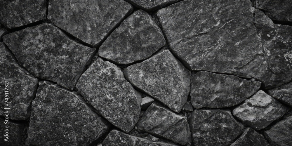 Fototapeta premium Black white stone texture. Rock surface. Close-up. Like a old rough concrete wall. Dark gray grunge background with space for design