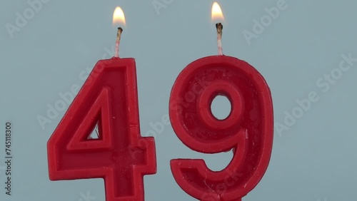 close up on a red number forty ninth birthday candle on a white background.
 photo
