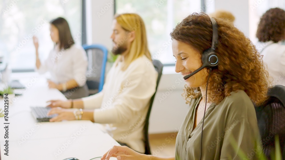 Fototapeta premium Telephone operator smiling sitting in the office