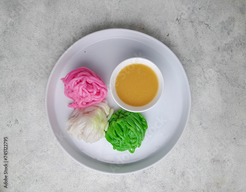 Kue putu mayang is an Indonesian Betawi string hopper dish made of starch or rice flour and coconut milk, then shaped like noodles. This noodle-like dish served with kinca in Betawi and Javanese 
 photo