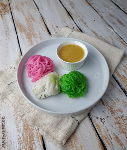Kue putu mayang is an Indonesian Betawi string hopper dish made of starch or rice flour and coconut milk, then shaped like noodles. This noodle-like dish served with kinca in Betawi and Javanese 
 photo