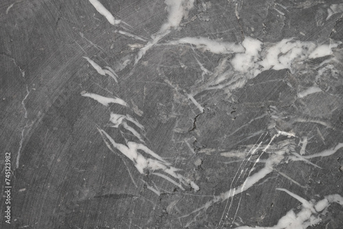 Close up of a black, grey marble with white veins. Natural black marble stone with white veins. Background photo texture, front view