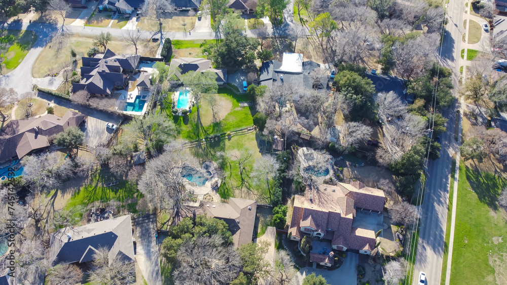 Low density housing upscale neighborhood, aerial view suburban houses with circular driveway, swimming pool, large backyard, residential single family homes, expensive area Dallas, Texas, USA