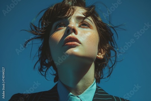 A beautiful woman in a male suit, emphasizing gender bender and non-binary concepts photo