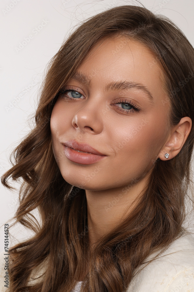 Beautiful young girl with fresh healthy skin. Woman advertise ear-rings. White background. Earrings closeup. Blond european woman with long hair with big lips, pretty smile. Cosmetology, scincare. Beautiful young girl with fresh healthy skin. Woman advertise ear-rings. White background. Earrings closeup. Blond european woman with long hair with big lips, pretty smile. Cosmetology, scincare.