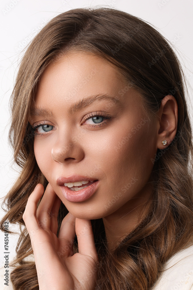 Beautiful young girl with fresh healthy skin. Woman advertise ear-rings. White background. Earrings closeup. Blond european woman with long hair with big lips, pretty smile. Cosmetology, scincare. Beautiful young girl with fresh healthy skin. Woman advertise ear-rings. White background. Earrings closeup. Blond european woman with long hair with big lips, pretty smile. Cosmetology, scincare.