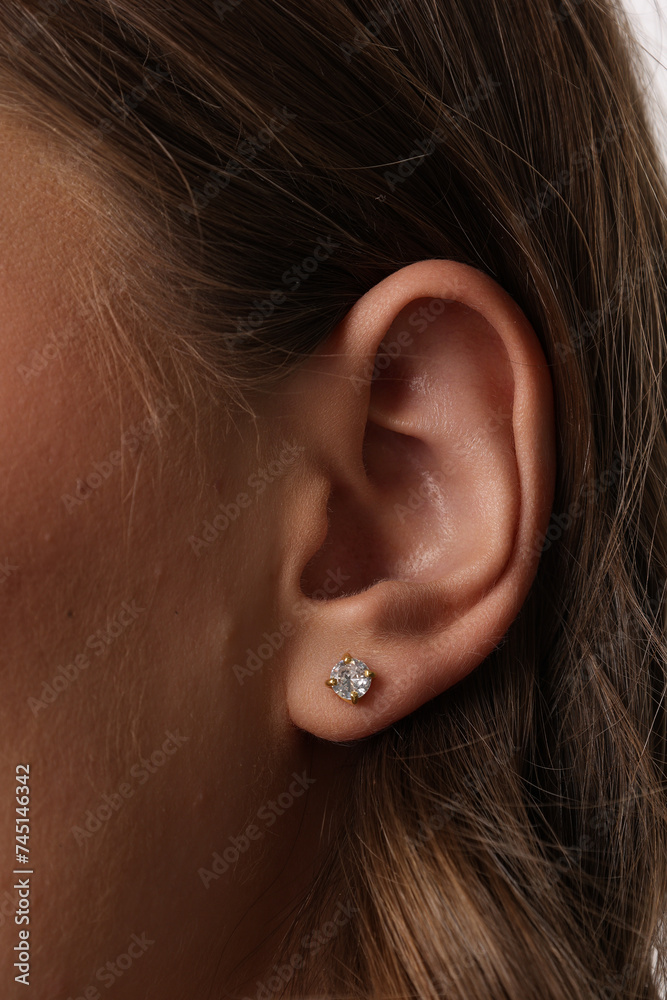 Beautiful young girl with fresh healthy skin. Woman advertise ear-rings. White background. Earrings closeup. Blond european woman with long hair with big lips, pretty smile. Cosmetology, scincare. Beautiful young girl with fresh healthy skin. Woman advertise ear-rings. White background. Earrings closeup. Blond european woman with long hair with big lips, pretty smile. Cosmetology, scincare.