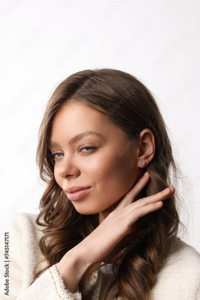 Beautiful young girl with fresh healthy skin. Woman advertise ear-rings. White background. Earrings closeup. Blond european woman with long hair with big lips, pretty smile. Cosmetology, scincare. Beautiful young girl with fresh healthy skin. Woman advertise ear-rings. White background. Earrings closeup. Blond european woman with long hair with big lips, pretty smile. Cosmetology, scincare.