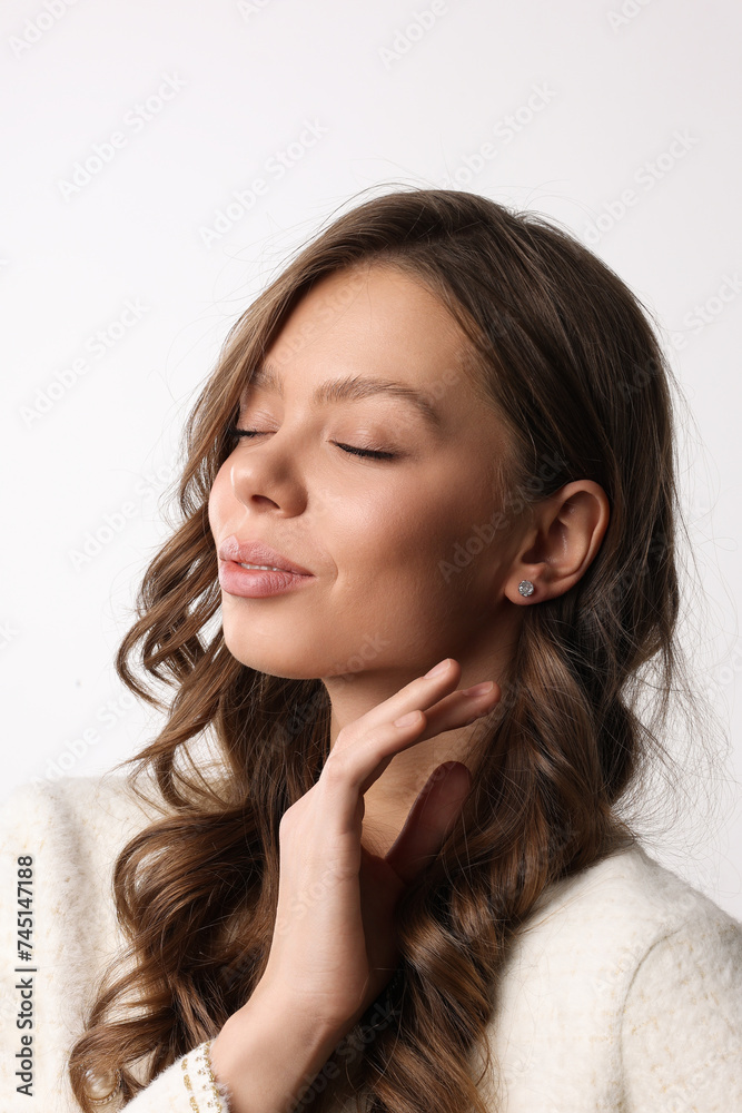Beautiful young girl with fresh healthy skin. Woman advertise ear-rings. White background. Earrings closeup. Blond european woman with long hair with big lips, pretty smile. Cosmetology, scincare. Beautiful young girl with fresh healthy skin. Woman advertise ear-rings. White background. Earrings closeup. Blond european woman with long hair with big lips, pretty smile. Cosmetology, scincare.