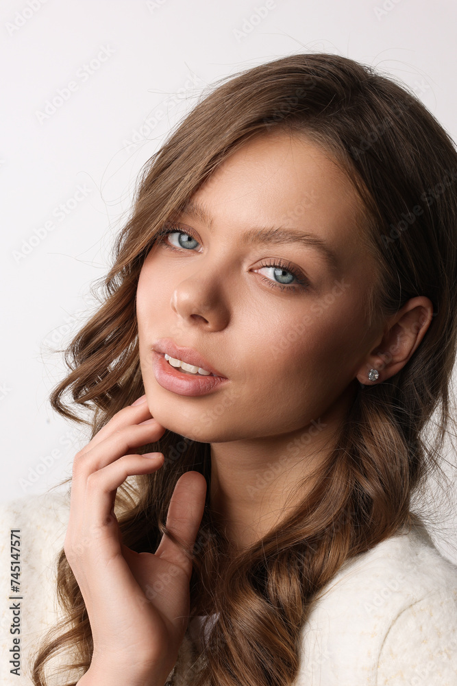 Beautiful young girl with fresh healthy skin. Woman advertise ear-rings. White background. Earrings closeup. Blond european woman with long hair with big lips, pretty smile. Cosmetology, scincare. Beautiful young girl with fresh healthy skin. Woman advertise ear-rings. White background. Earrings closeup. Blond european woman with long hair with big lips, pretty smile. Cosmetology, scincare.