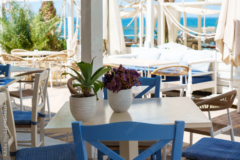 Fototapeta premium Restaurant at the Mediterranean Sea, Greece.
