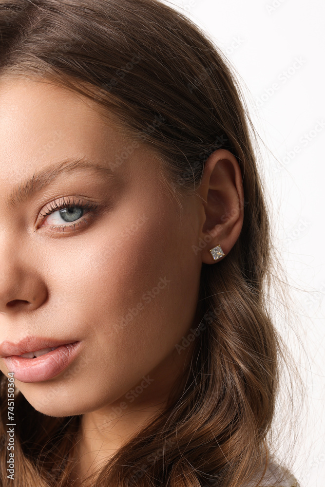Beautiful young girl with fresh healthy skin. Woman advertise ear-rings. White background. Earrings closeup. Blond european woman with long hair with big lips, pretty smile. Cosmetology, scincare Beautiful young girl with fresh healthy skin. Woman advertise ear-rings. White background. Earrings closeup. Blond european woman with long hair with big lips, pretty smile. Cosmetology, scincare