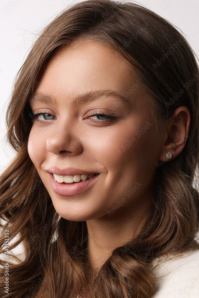Beautiful young girl with fresh healthy skin. Woman advertise ear-rings. White background. Earrings closeup. Blond european woman with long hair with big lips, pretty smile. Cosmetology, scincare Beautiful young girl with fresh healthy skin. Woman advertise ear-rings. White background. Earrings closeup. Blond european woman with long hair with big lips, pretty smile. Cosmetology, scincare