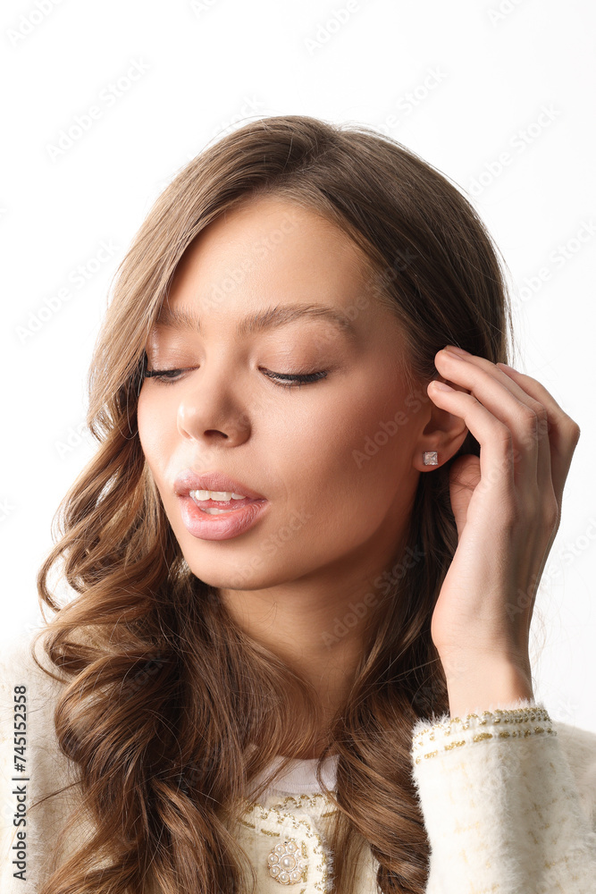 Beautiful young girl with fresh healthy skin. Woman advertise ear-rings. White background. Earrings closeup. Blond european woman with long hair with big lips, pretty smile. Cosmetology, scincare Beautiful young girl with fresh healthy skin. Woman advertise ear-rings. White background. Earrings closeup. Blond european woman with long hair with big lips, pretty smile. Cosmetology, scincare