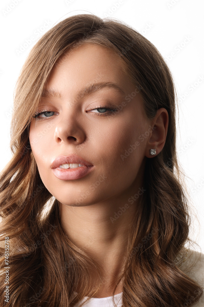Beautiful young girl with fresh healthy skin. Woman advertise ear-rings. White background. Earrings closeup. Blond european woman with long hair with big lips, pretty smile. Cosmetology, scincare Beautiful young girl with fresh healthy skin. Woman advertise ear-rings. White background. Earrings closeup. Blond european woman with long hair with big lips, pretty smile. Cosmetology, scincare