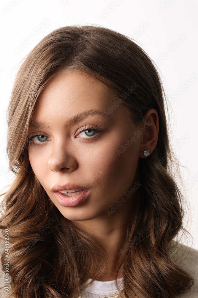 Beautiful young girl with fresh healthy skin. Woman advertise ear-rings. White background. Earrings closeup. Blond european woman with long hair with big lips, pretty smile. Cosmetology, scincare Beautiful young girl with fresh healthy skin. Woman advertise ear-rings. White background. Earrings closeup. Blond european woman with long hair with big lips, pretty smile. Cosmetology, scincare